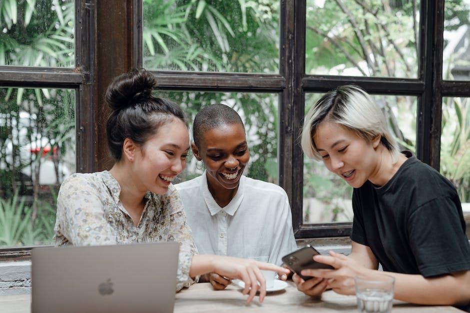 Three people sharing contact information